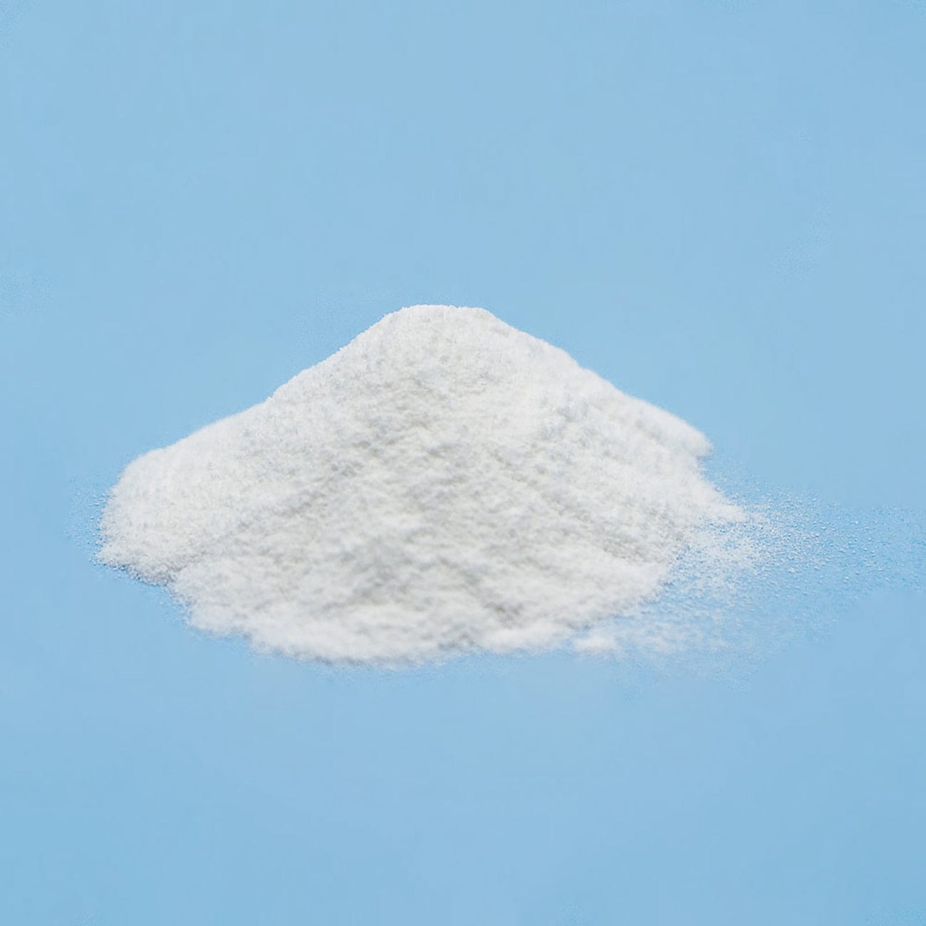 Copovidone-Pile of white Copovidone USP Powder on light blue background-Excipient-Granules