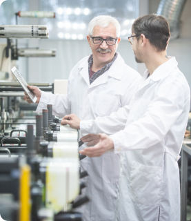 2 staff members on a supplement production line