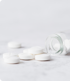 White tablets that fell out of a glass bottle-Supplements-Nutraceutical