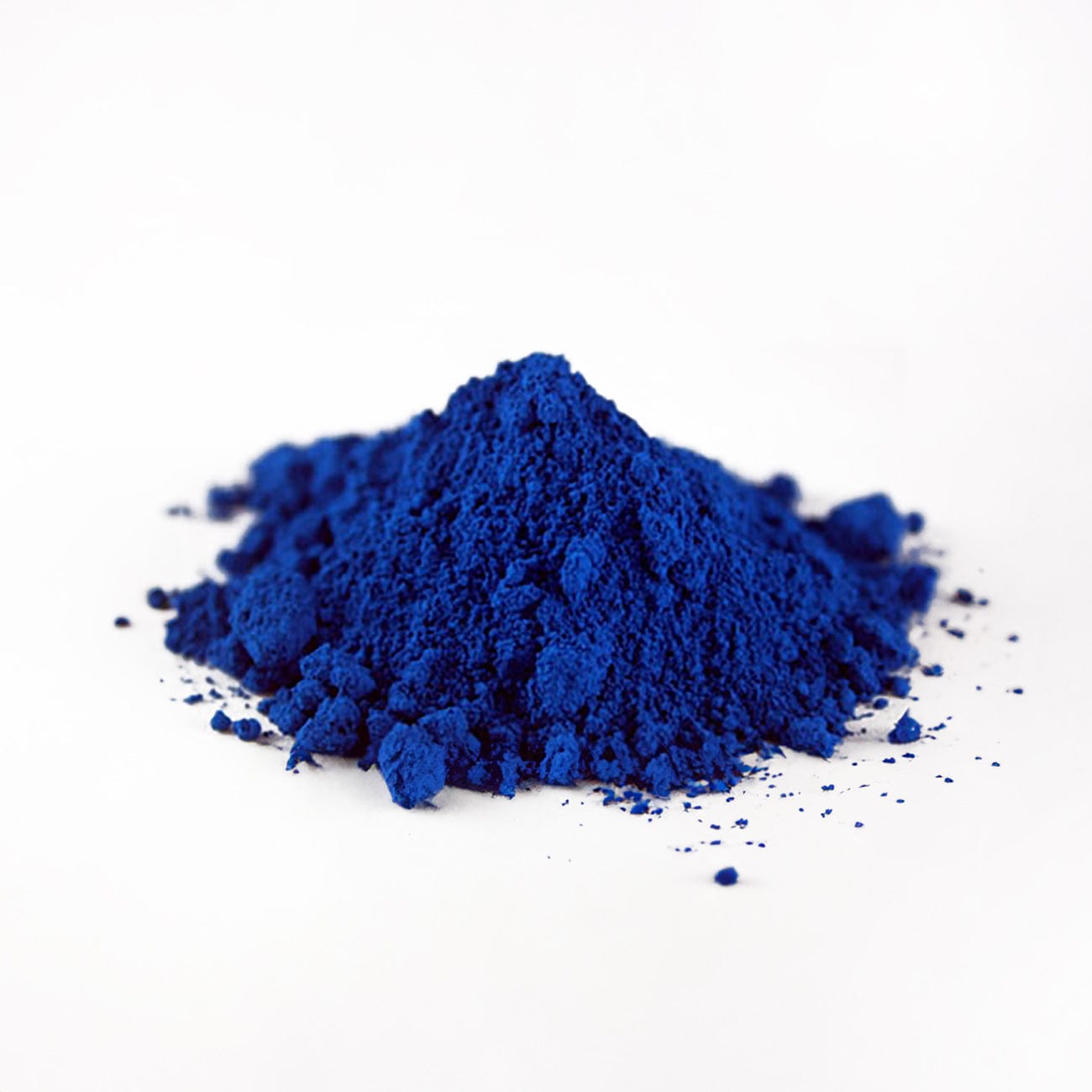 FD&C Blue #1-Pile of FD&C Blue #1 powder on white background-Excipient-Granules