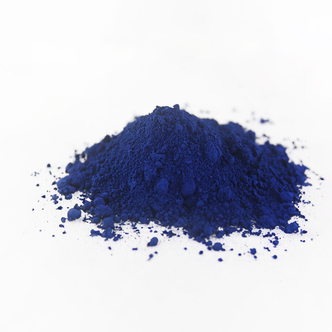 FD&C Blue #2-Pile of FD&C Blue #2 powder on white background-Excipient-Granules